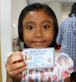 7-year-old Sarocha Pachaporn smiles after receiving her first ID card.